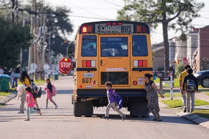 High school students exiting a building during the morning as the school day begins in a California public district.