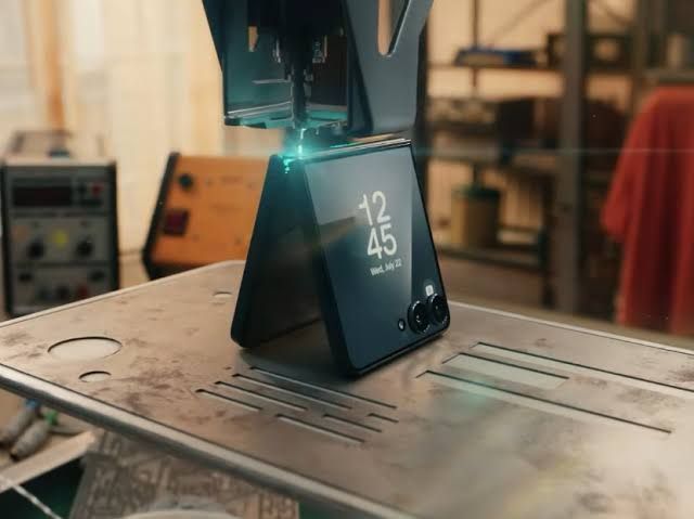 Peter Parker's high-tech fabricator constructing a new Samsung Galaxy Z Flip 8 smartphone.