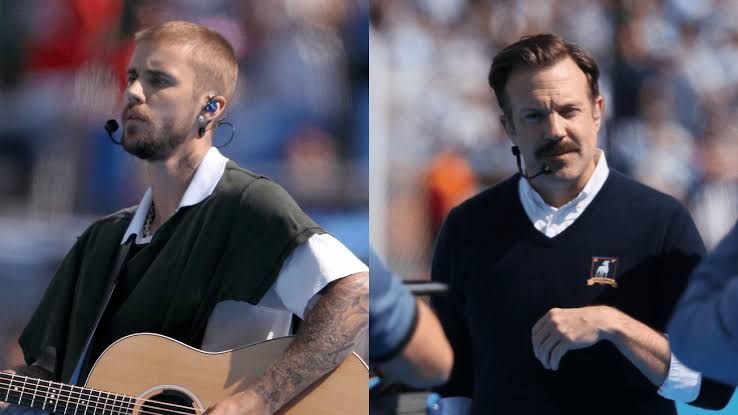 Justin Bieber and Jason Sudeikis as Ted Lasso standing together on the field at the FIFA World Cup Final.