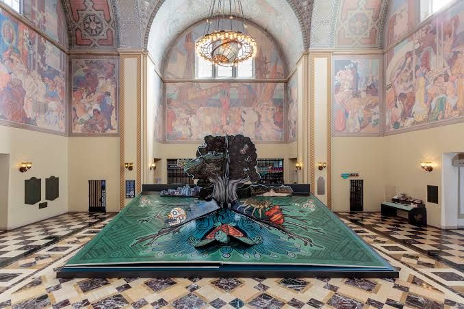 Visitors view the 11-foot tall record-breaking pop-up book installation inside the Los Angeles Central Library rotunda.