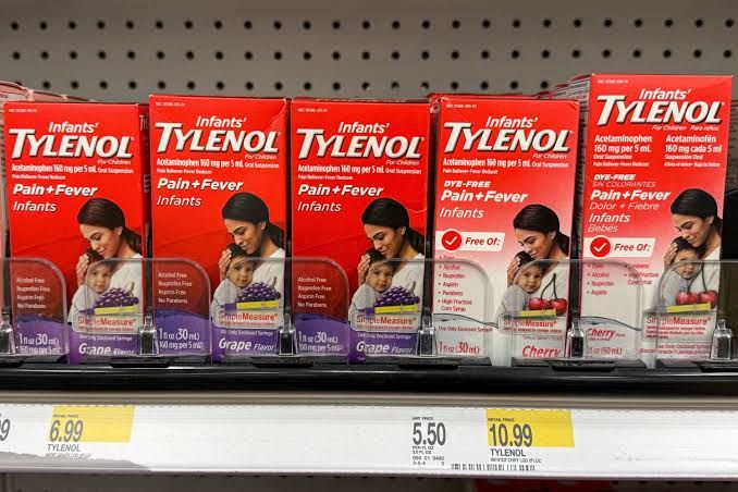 Close-up of Tylenol infant medication packaging on a pharmacy shelf.