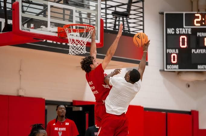 NC State basketball players during practice sessions focused on front court development and team drills.