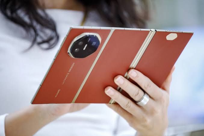 The Huawei Mate XT smartphone displayed in a trifold configuration showing its large screen.
