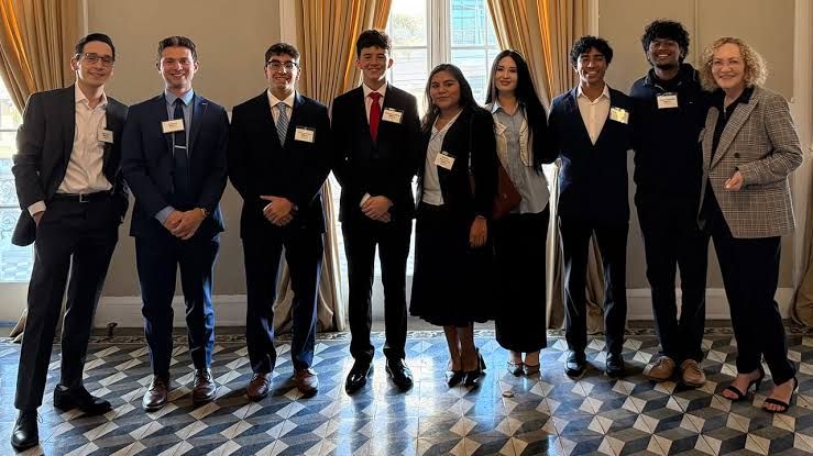 Members of Mu Nu Upsilon fraternity attending a professional networking event hosted by the Business Transition Council.