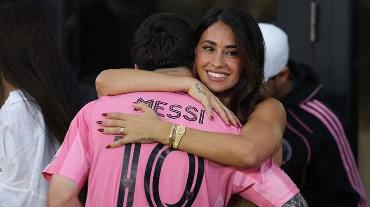 Lionel Messi and Antonela Roccuzzo embrace on the field following the 2025 MLS Cup Final win in Fort Lauderdale.