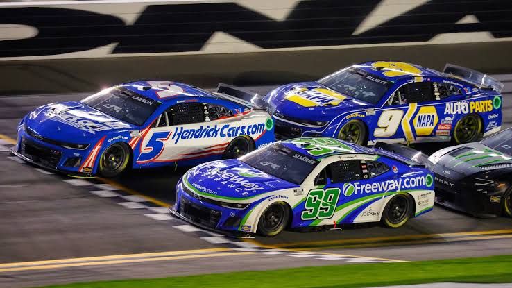 NASCAR stock cars racing in a tight pack at Daytona International Speedway during a Cup Series event.