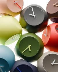 HoHyeon Lim's Edge Clock resting on the sharp corner of a wooden desk surface.