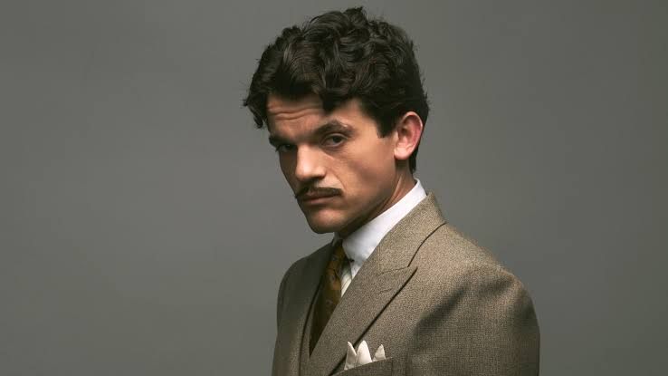 Edward Bluemel as a young Hercule Poirot in a period-accurate suit on the set of the new BBC drama.