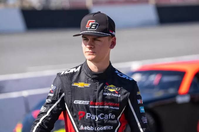 NASCAR driver Carson Brown stands on the track during a race weekend in the O’Reilly Series.