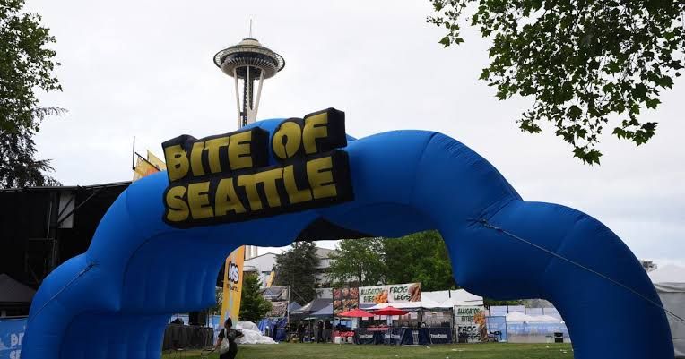 Police officers securing the scene near the Space Needle following a shooting at the Bite of Seattle festival.