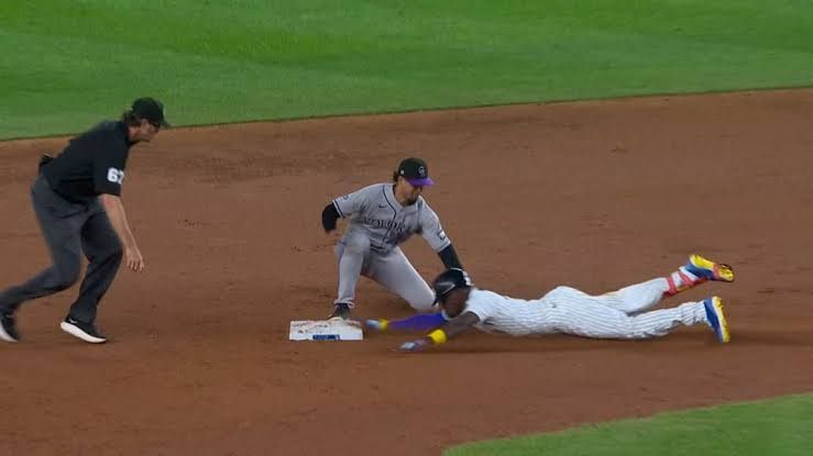 Jazz Chisholm Jr. slides into second base during a game between the Yankees and the Rockies.