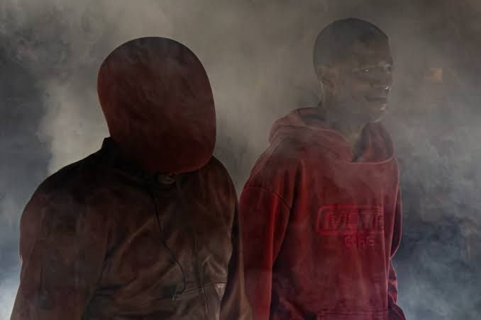 Ye and Kid Cudi performing together on a massive stage at Soldier Field in Chicago for a sold-out concert.
