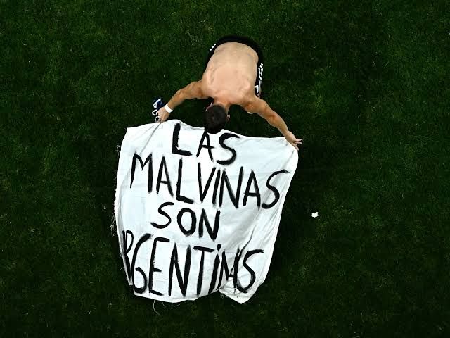 Argentina players display a political banner regarding the Falkland Islands after beating England at the 2026 World Cup.