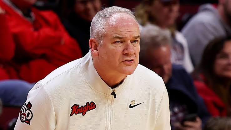 Steve Pikiell standing on the court at Jersey Mike's Arena during a Rutgers Scarlet Knights game.