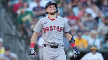 Curtis Mead in a Red Sox uniform stands on the field during his debut before his wrist injury.