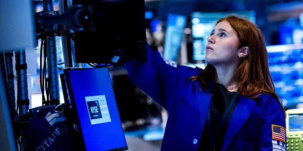 Goldman Sachs signage displayed on the New York Stock Exchange floor during high market activity.