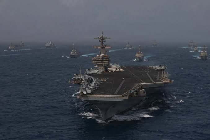 US Navy warships in formation transiting the Arabian Sea during a military operation.