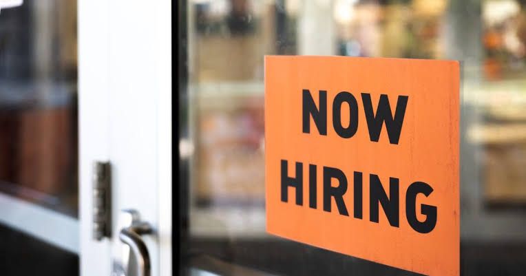 Employment recruitment sign in a business window, signifying current hiring trends in Pennsylvania.