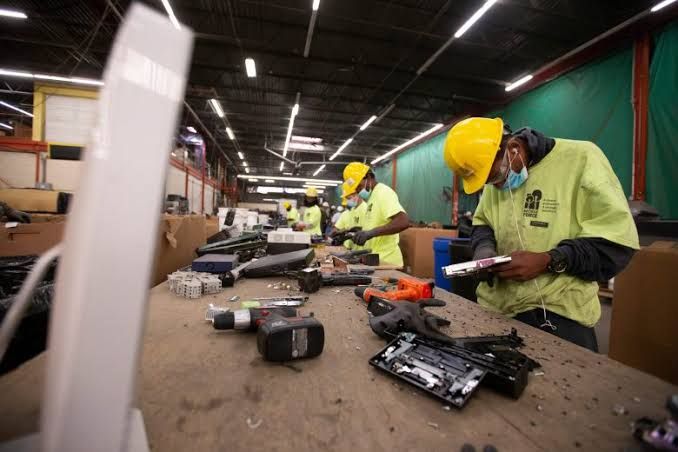An employee dismantles computer parts at the RecycleForce facility in Indianapolis as part of a reentry job training program.