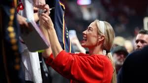 Sophie Cunningham signs autographs for fans outside the Moda Center before an Indiana Fever game in Portland.