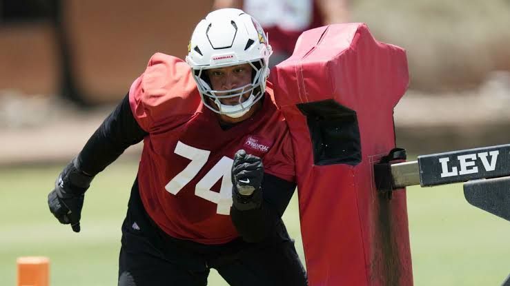Arizona Cardinals offensive lineman Isaiah Adams standing on the field during a practice session.
