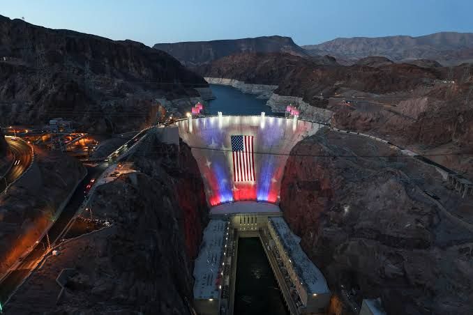 American flag hanging over Hoover Dam at Lake Mead as water levels reach historic lows during the 2026 drought.
