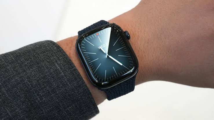 An Apple Watch Series 12 displayed on a table next to accessories during the official product announcement.