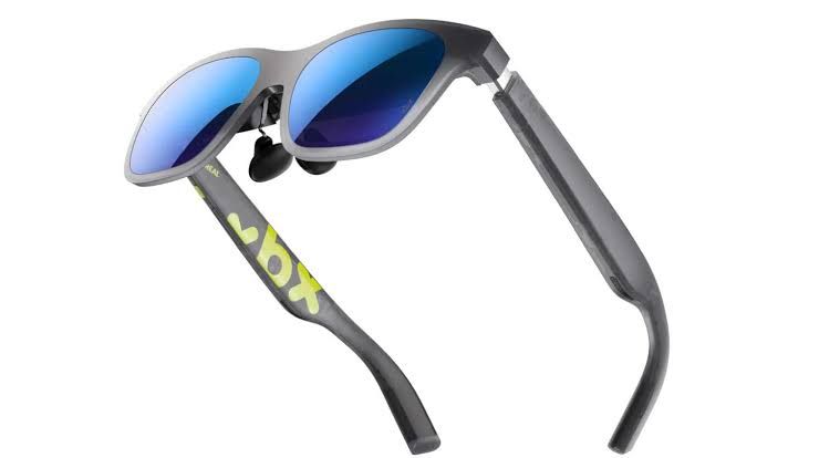 Xreal A01+ AR glasses displayed alongside a compatible handheld gaming device on a clean background.