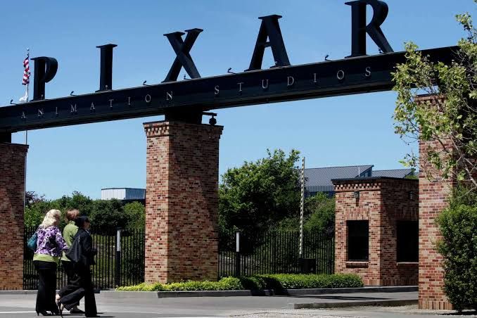 Pixar Animation Studios employees walking past the Emeryville campus entrance in the Bay Area.