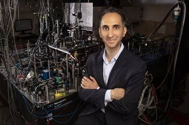 Brian DeMarco, professor and director of HQAN, in a lab setting discussing quantum research.
