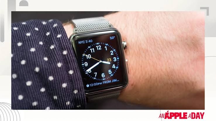Close-up of a vintage Apple Watch displaying health rings on a user's wrist during a tech product review.