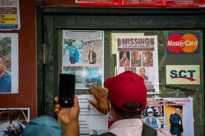 A board in Devighat covered with pictures of missing persons following the 2026 Nepal flash floods.