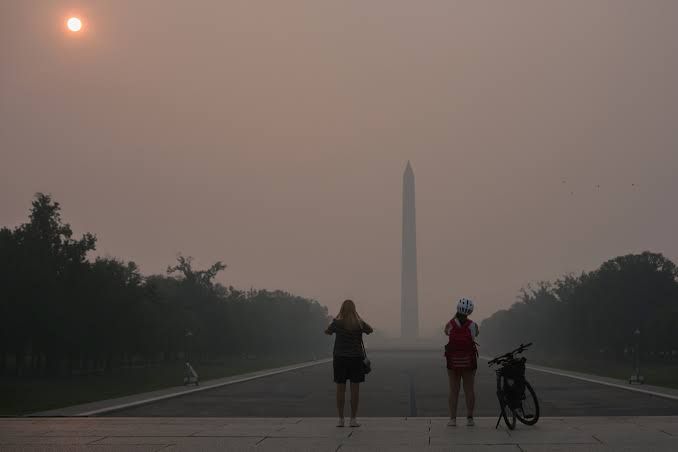 Wildfire smoke obscures the sun and the midtown Manhattan skyline on a hazy Friday morning.