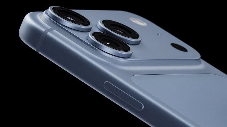 Apple representative showing the iPhone 18 Pro in burgundy during the fall launch event presentation.