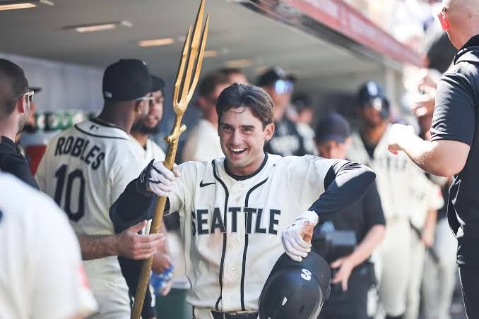 Cole Young follows through on a swing at the plate during a game at T-Mobile Park.