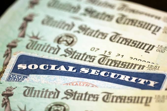 A Social Security card displayed next to U.S. Treasury checks on a desk in Washington D.C.
