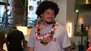 USC quarterback Jayden Maiava speaking at an alumni event at the Alohilani Resort regarding mental health awareness.