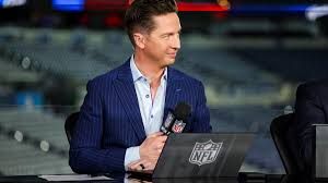 NFL Network reporter Tom Pelissero standing on a field during a professional football broadcast report.