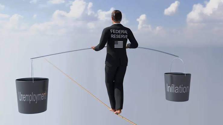 A conceptual image of a tightrope walker balancing heavy buckets representing inflation and unemployment on a long pole.