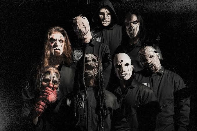 Slipknot members in masks performing in a dark, surreal music video set for their new single Arsenal.