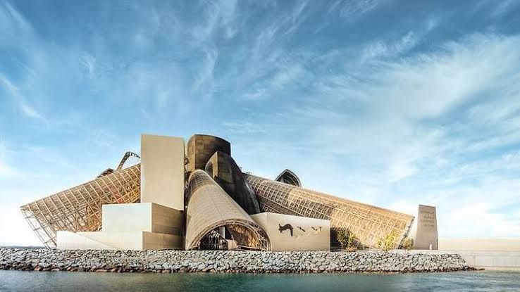 The exterior of the Guggenheim Abu Dhabi featuring large sculptural cones on Saadiyat Island.
