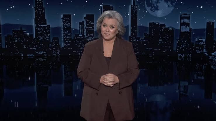 Rosie O'Donnell stands on the Jimmy Kimmel Live stage during a guest-hosting monologue.