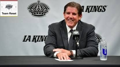 Peter Laviolette standing on the ice wearing a Los Angeles Kings jacket during his introductory press conference.