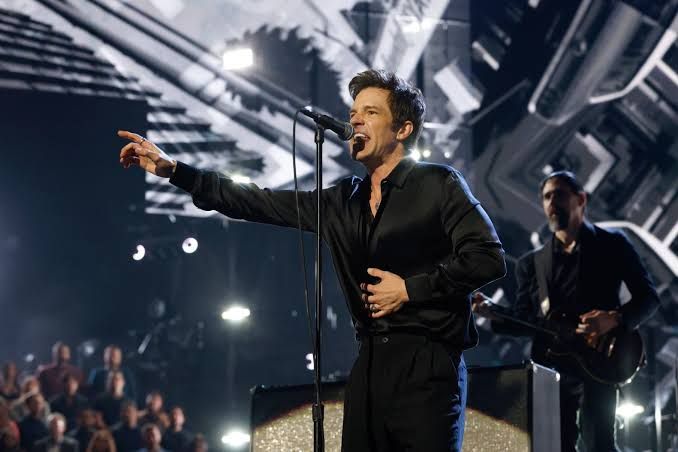 Brandon Flowers performing on stage at the 2025 Rock and Roll Hall of Fame ceremony in Los Angeles.