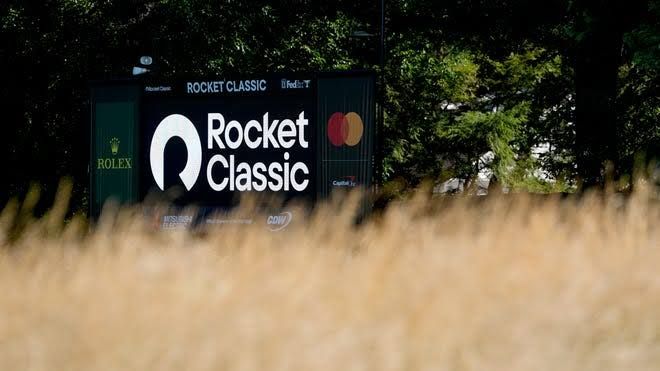 Golfers competing on the green at the Detroit Golf Club during the Rocket Classic tournament.
