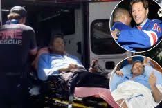 Ron Duguay being loaded into an ambulance by emergency responders after a health incident at his home.