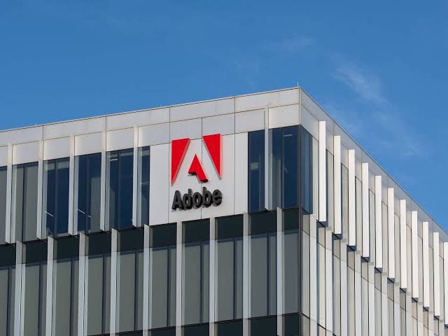 Adobe Creative Cloud logo displayed on a professional workstation screen.