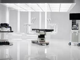 The OTTAVA robotic surgical system featuring four table-integrated arms in a sterile operating room environment.
