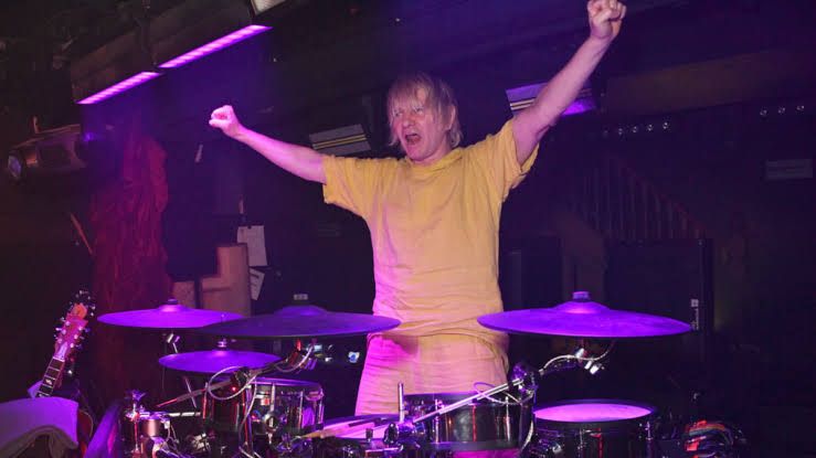 Zak Starkey performing on drums during a live concert for The Who, highlighting his return to the touring lineup.