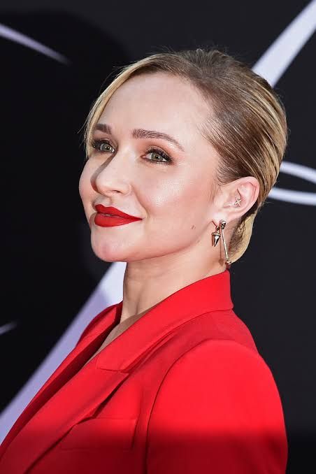 Hayden Panettiere posing on a red carpet during a promotional event for her television work.